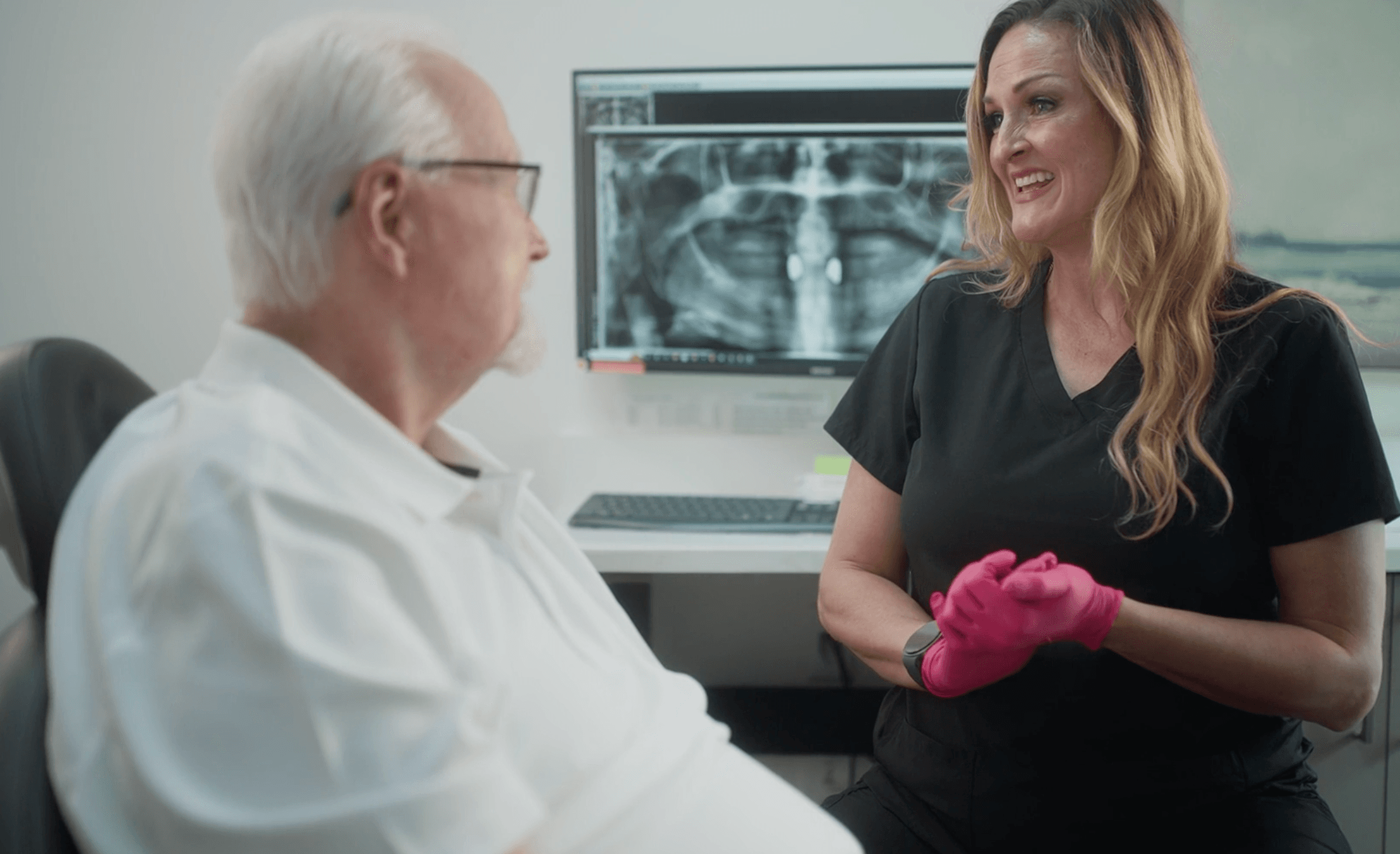 A treatment coordinator talking with a patient at St. Pete Family & Cosmetic Dentistry.