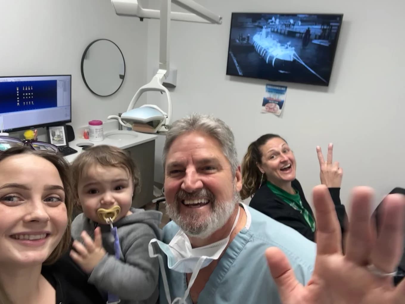 Dr. Powless with patients at St. Pete Family & Cosmetic Dentistry.