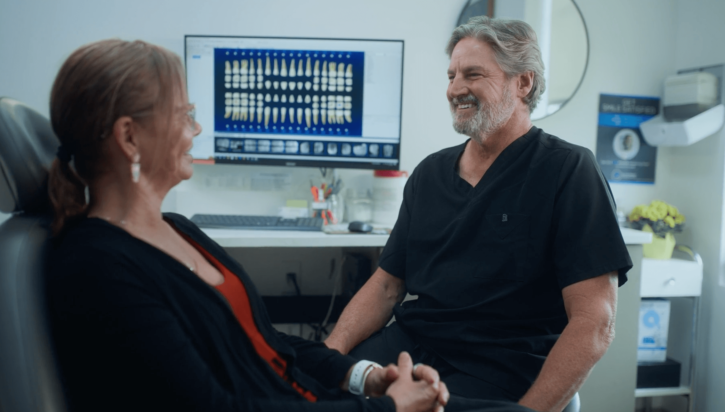 Dr. Powless talking with a patient at St. Pete Family & Cosmetic Dentistry.
